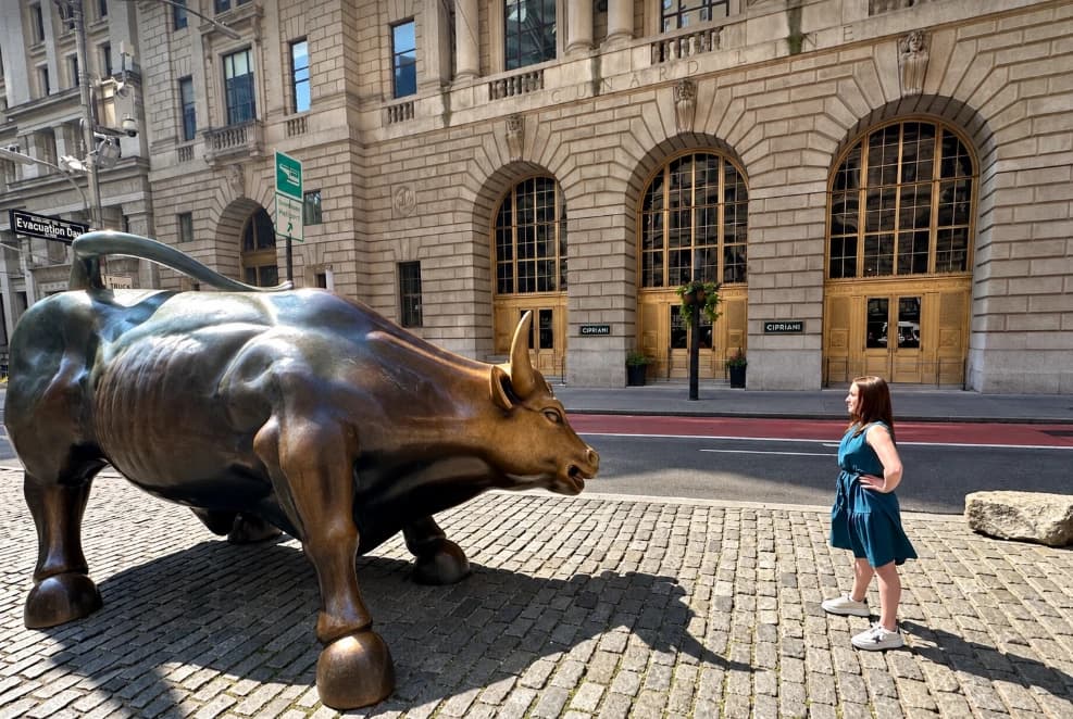 Sophia DeGregorio facing the Charging Bull statue on Wall Street