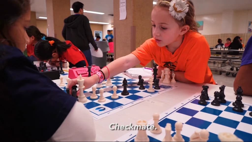 Sophia delivering checkmate against an opponent, subtitled Checkmate.