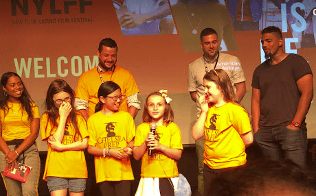Sophia speaking on stage with teammates at the Her Move Next documentary premiere