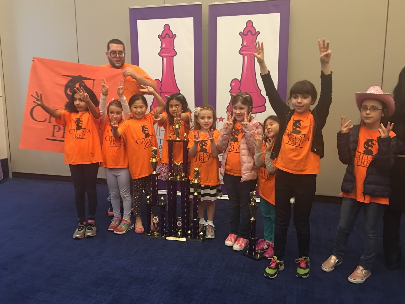 The Chelsea Prep chess team posing with their trophy at the All-Girls National Chess Championships